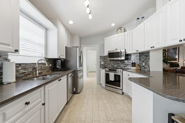 Kitchen with tile backsplash and granite
