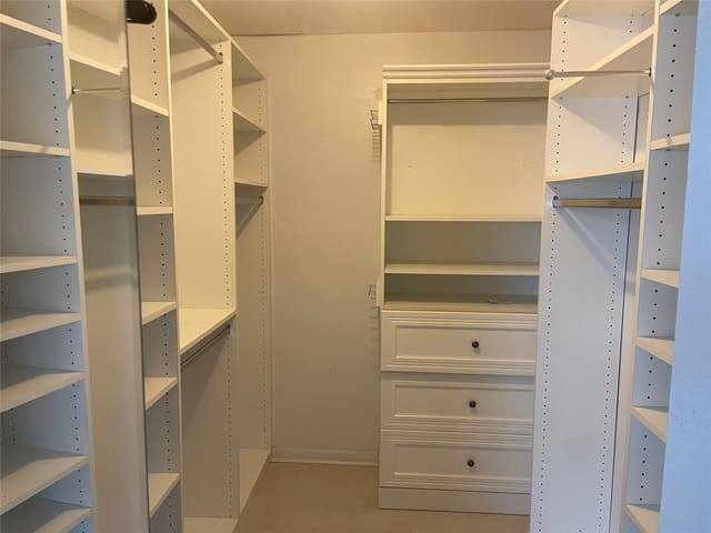 walk in closet with built in shelves