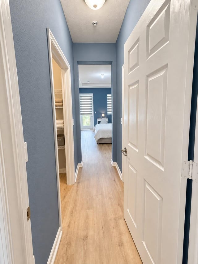 Bright blue-gray primary bedroom entry